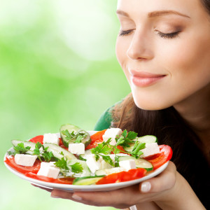 Portrait of happy smiling woman with plate of salad